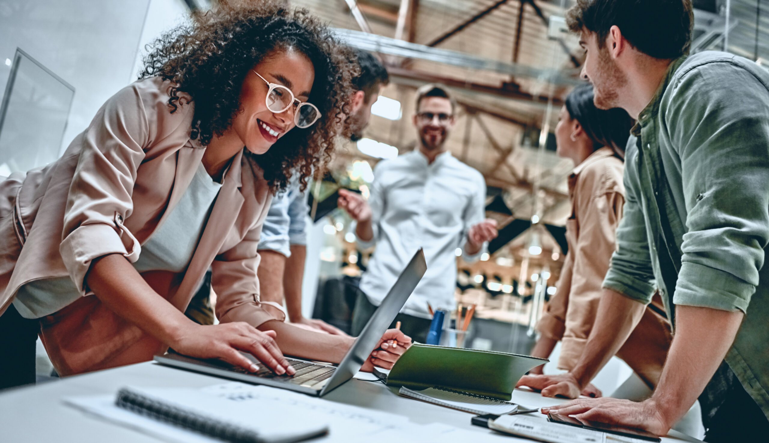 Young business people in office Group of young multiracial business people are working in modern office. Freelancers in coworking place. Creative and stylish youth.